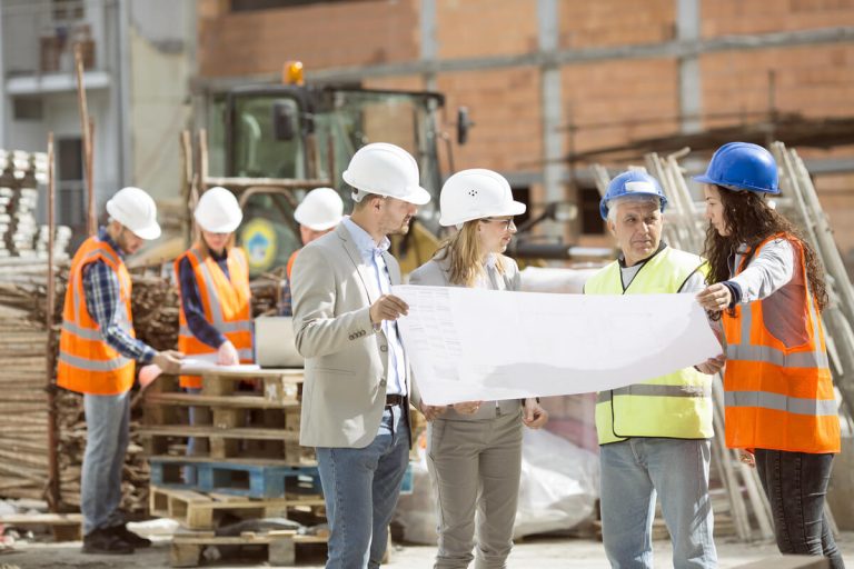 Construction workers discussing work at construction site